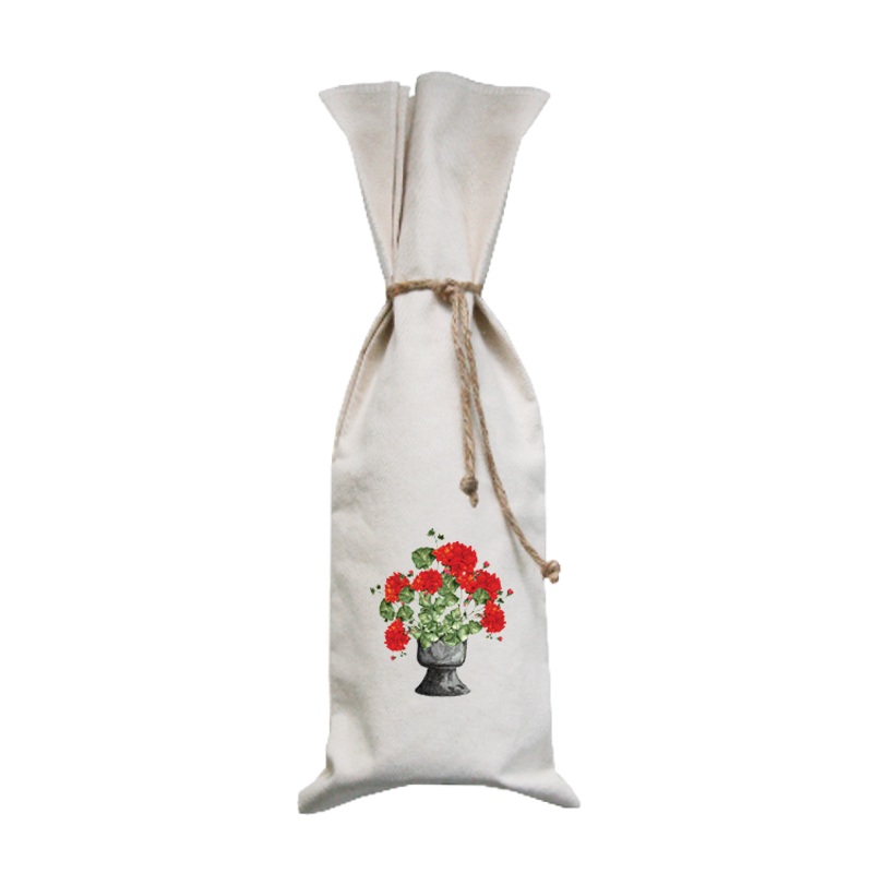 red geraniums in black pot wine bag